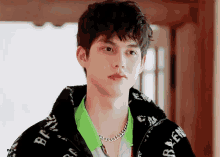 a young man wearing a jacket that says balenciaga