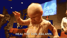 a baby dancing with the words heal thy son kalann