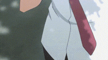 a close up of a person wearing a tie and a white shirt .