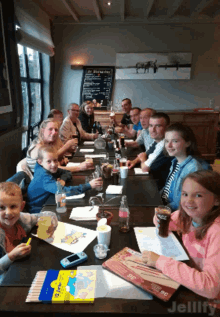 a group of people sitting at a table with jellyfy in the corner