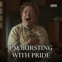 a woman says i 'm bursting with pride with a hbo logo in the background