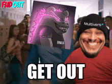 a man wearing a multiverse hat holds up a picture of a monster and says " get out "