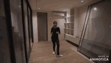 a woman is standing in a room with the words made in animotica on the bottom right