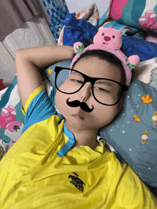 a boy wearing glasses and a headband with a teddy bear on it