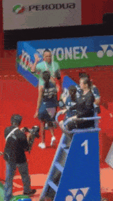 a yonex sign is in the background of a badminton game