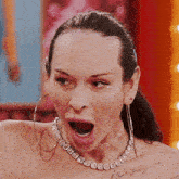a woman wearing a choker and hoop earrings has a tattoo on her chest that says " i love you "