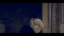 a man with blonde hair is standing in a dark room with a brick wall