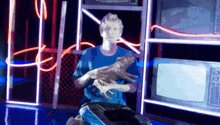 a man in a blue shirt is holding a stuffed animal