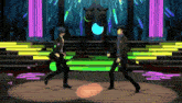 two men are dancing on a stage with neon lights