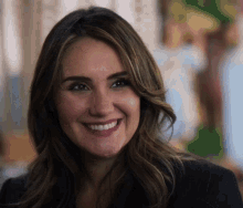 a close up of a woman 's face smiling for the camera