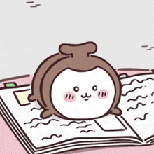 a cartoon of a monkey sitting on top of a book .