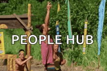 a group of people are standing in a field with the words people hub above them .