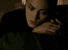 a close up of a woman 's face with a dark background