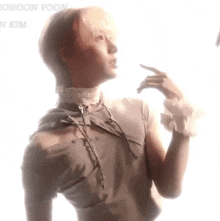 a man wearing a choker and ruffled sleeves is looking up