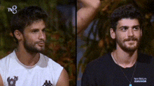 two men are standing next to each other and one of them is wearing a black shirt that says survivor .