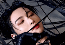 a close up of a person 's face with the letter w visible in the corner