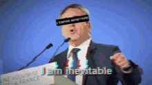 a man speaking into a microphone with a band around his eyes that says " l' empire monetaire " on it