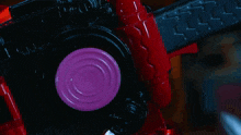 a close up of a person 's hand holding a pink object