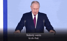 a man in a suit and tie stands at a podium with the words " nobody wants to do that " written below him