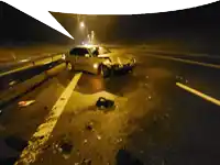 a car that has been involved in an accident is laying on the side of the road