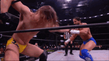 two wrestlers are fighting in a ring that says draft king on the side