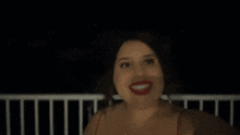a woman in a red top is smiling and the word shagarita is on the bottom of the image
