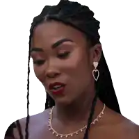 a woman wearing a heart shaped earring and a gold necklace
