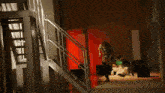 a woman is running down a set of stairs in front of a colorful display