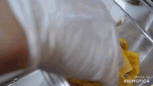 a person is putting food in a container that says made in animotica on it