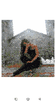 a woman in a black jumpsuit is sitting on a brick wall with a white purse and giving a peace sign