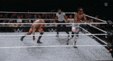 two wrestlers are in a wrestling ring with a referee and a sign that says w