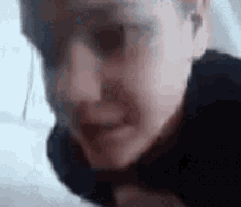 a close up of a person 's face with a blurry background and a blurred background .