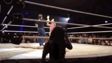 a woman taking a picture of a wrestler in a boxing ring