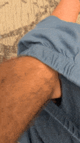 a close up of a person 's arm with a blue shirt
