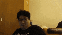 a man wearing glasses and a black shirt that says " i love you "