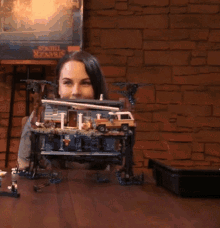 a woman looks at a lego stranger things set on a table
