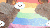 two people holding hands in front of a rainbow flag with a smiling cloud on their wrist