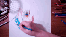 a person is drawing a person 's face on a piece of paper with colored pencils on the table