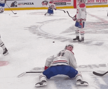 a hockey game is being played with a pizza ad in the background
