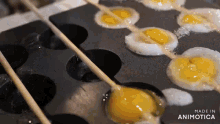 eggs are being cooked in a pan that says made in animonica
