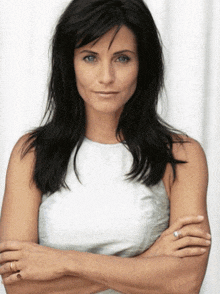 a woman with her arms crossed wearing a ring