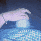 a person wearing a bracelet is pressing a button on a keyboard