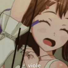 a close up of a girl holding a violin with the word viole written on her face .