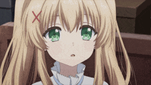 a girl with blonde hair and green eyes has a red x on her hair