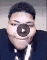 a close up of a man 's face with a play button in the corner