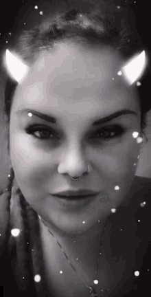 a woman with horns on her head is wearing a nose ring and a nose ring .