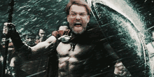 a man without a shirt is holding a spear and yelling