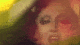 a close up of a woman 's face with a lot of makeup on .