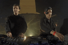 two men are playing music in front of a rampage logo