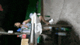 a woman sits at a table with a bottle of coca cola on it